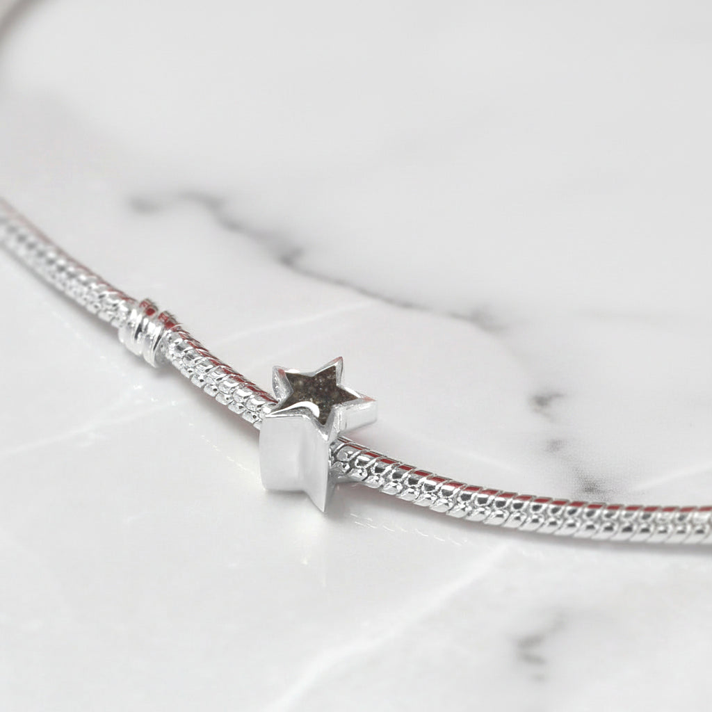 Charm de Cenizas en Estrella de Plata