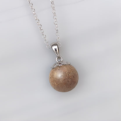 Colgante de plata · Perla con arena o tierra