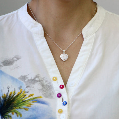 Colgante de plata con partículas de cordón umbilical en corazón de plata sencillo.
