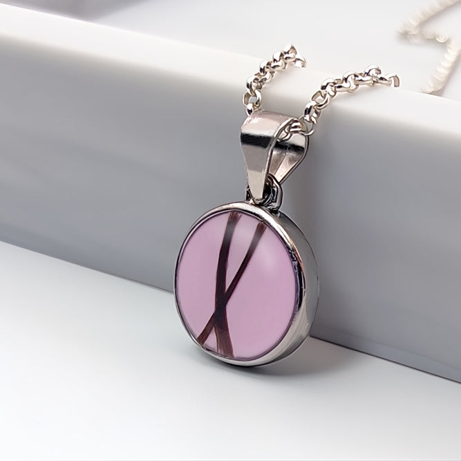Colgante con pelo · Circulo de plata con pelo